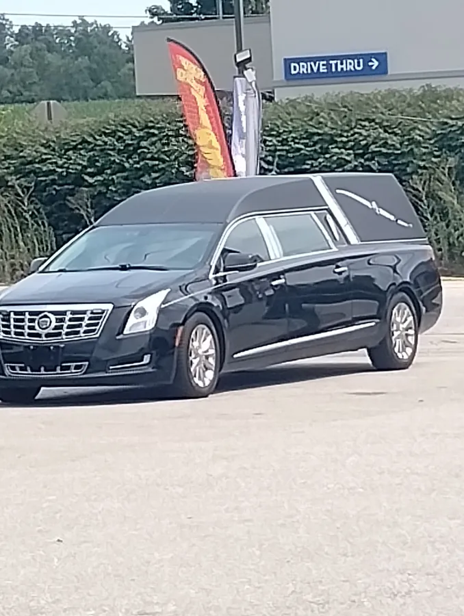 Black Cadillac funeral coach after a full exterior detail